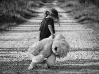 Mädchen mit Teddybär im Arm, schwarz-weiß-Fotografie